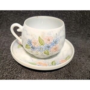 vintage hand-painted porcelain teacup and saucer set with a forget-me-not floral